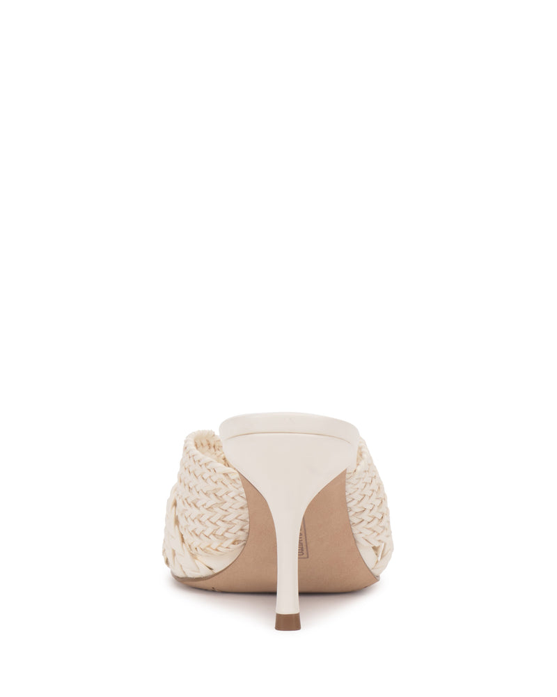 Rear view of the Vince Camuto Pheya Mule, a high-heeled sandal in light beige with woven side detailing and a single heel, shown against a white background.