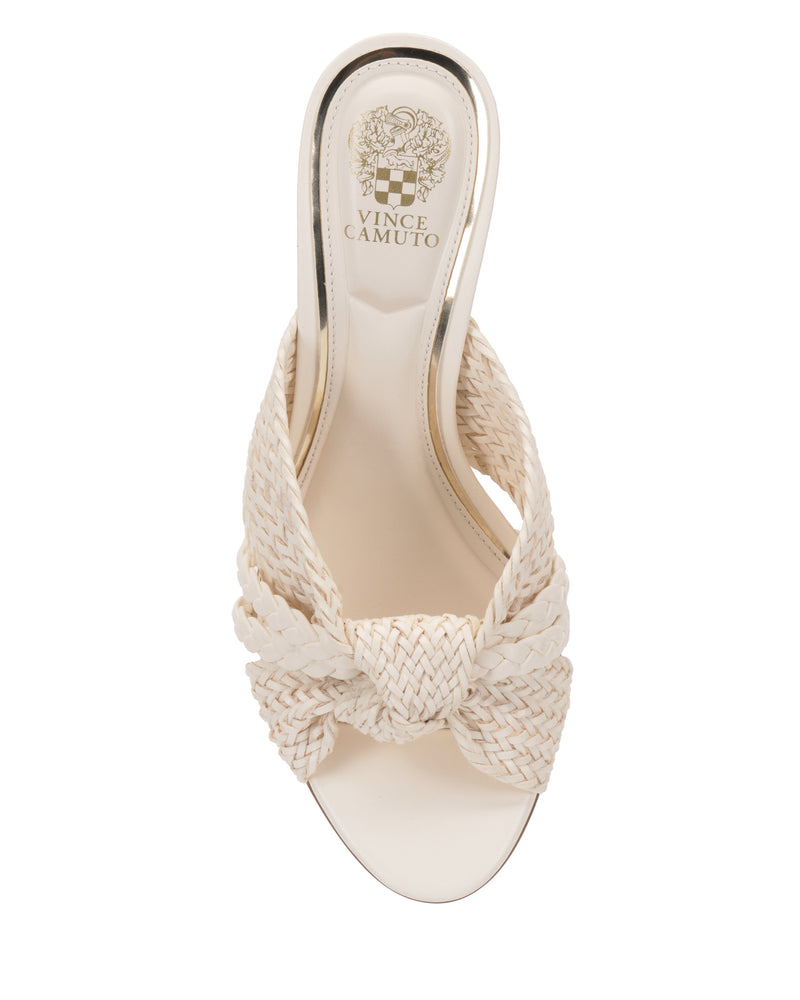 Top view of the cream-colored Vince Camuto Pheya Mule, featuring a braided design across the open toe, a high heel, and the brand logo on the insole.