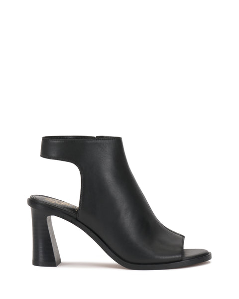 The Vince Camuto Rimdia Sandal is a black peep toe bootie featuring ankle cutouts and a sturdy block heel, displayed in side profile against a white background.