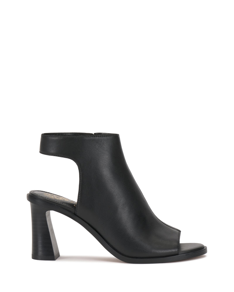 The Vince Camuto Rimdia Sandal is a black peep toe bootie featuring ankle cutouts and a sturdy block heel, displayed in side profile against a white background.