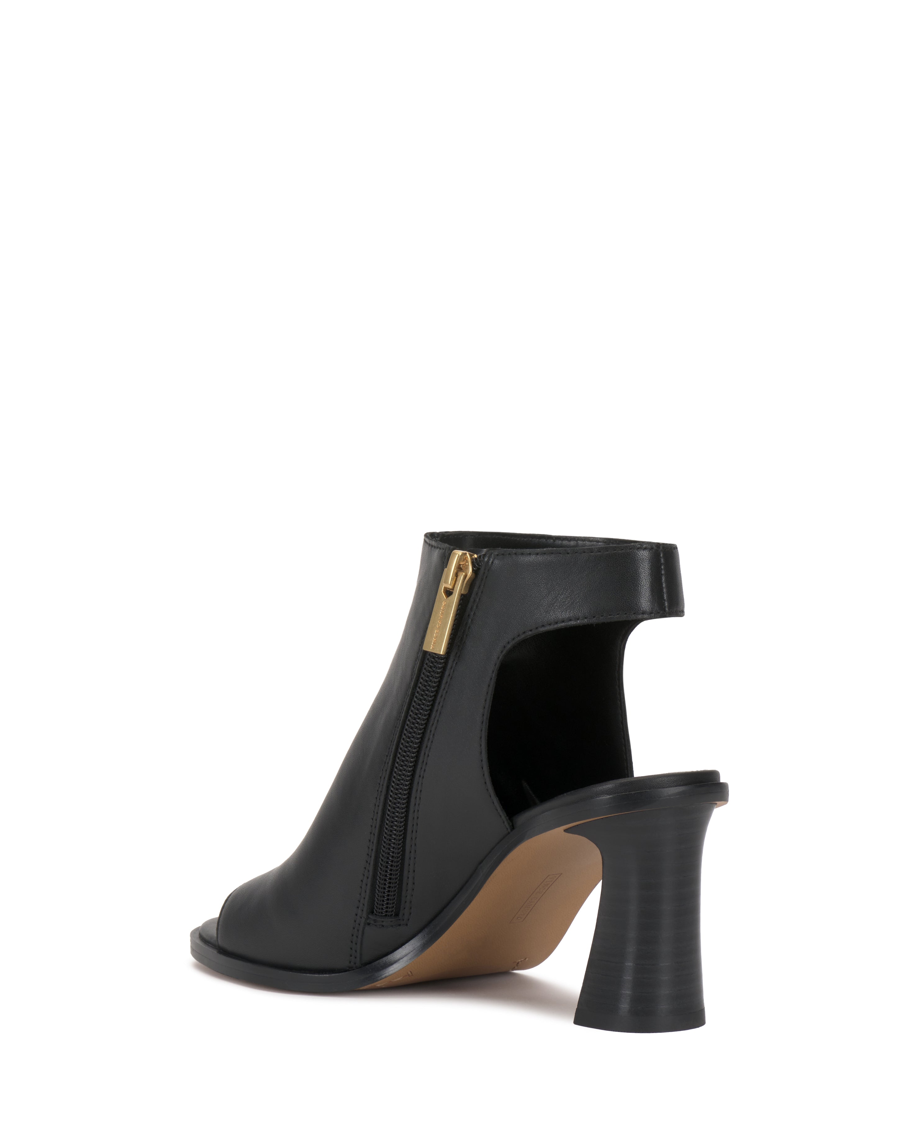 The Rimdia Sandal by Vince Camuto features a black peep toe, side zipper, and open heel with a chunky stacked block heel. The shoe is showcased against a white background.