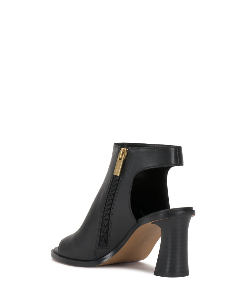 The Rimdia Sandal by Vince Camuto features black peep toes, a side zipper, cut-out heel section, and flared block heel, displayed against a white background.