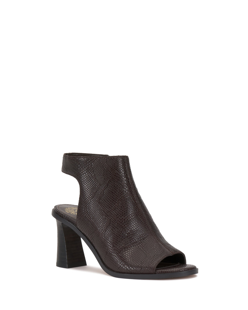 The Vince Camuto Rimdia Sandal, a dark brown textured slingback with a peep toe, cutout heel, and open back, is shown against a white background.