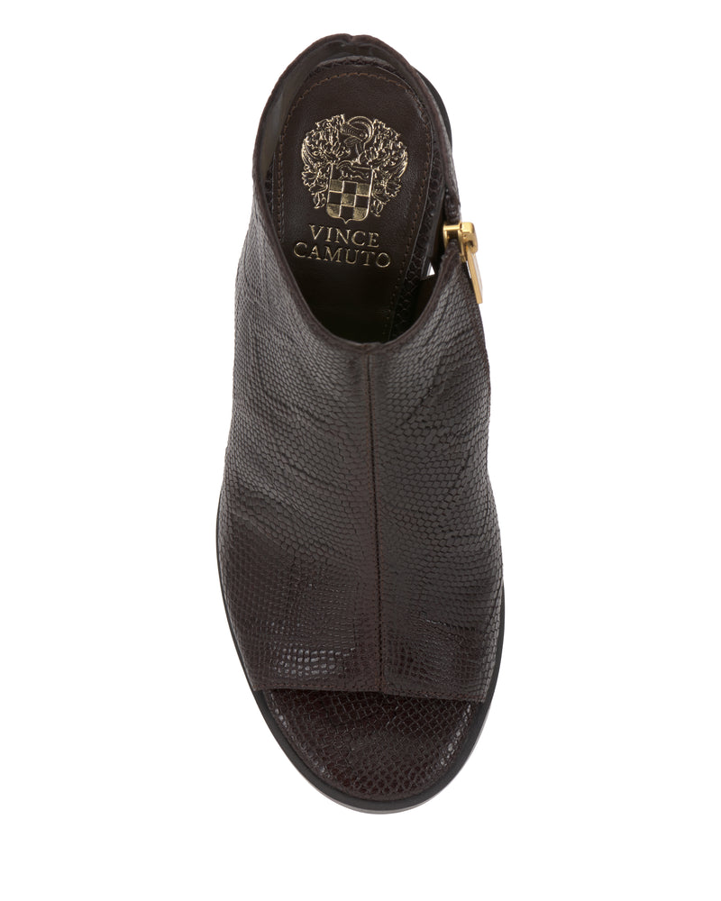 A top view of the Vince Camuto Rimdia Sandal—a dark brown, textured leather peep toe block heel shoe with a gold side zipper and Vince Camuto branding on the insole.