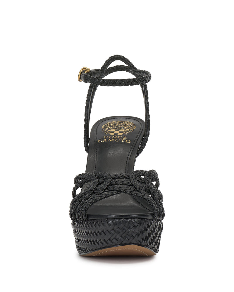 Front view of the Samlee Strappy Platform Sandal by Vince Camuto, featuring black braided straps, a gold-buckled ankle strap, thick textured platform sole, and gold branding on the footbed for chic woven style.