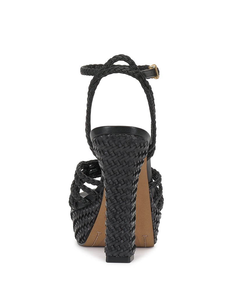 Rear view of the Vince Camuto Samlee Strappy Platform Sandal in black with a chunky block heel, woven braided texture, ankle strap with gold buckle, and tan sole.