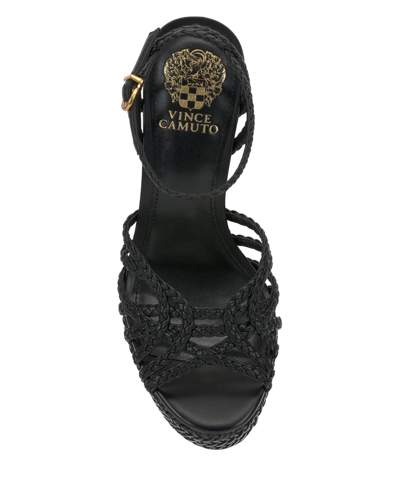 The Vince Camuto Samlee Strappy Platform Sandal features black woven straps, an ankle strap with a gold buckle, a chunky block heel, and the signature gold crest logo on the insole. Viewed from above.
