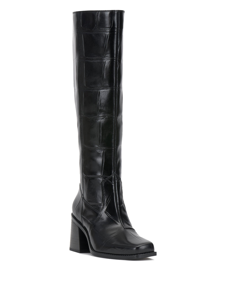 The Sangeti Wide Calf Boot by Vince Camuto is a black, knee-high leather boot featuring a block heel and square toe with a glossy, patchwork texture design. The boot is photographed against a plain white background.