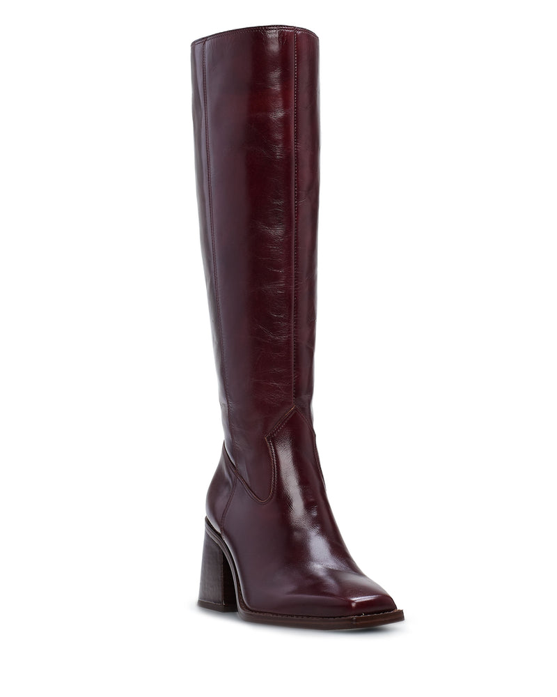 The Sangeti Boot by Vince Camuto is a tall, shiny burgundy leather knee-high boot with a block heel and square toe, shown at a three-quarter angle on a white background.