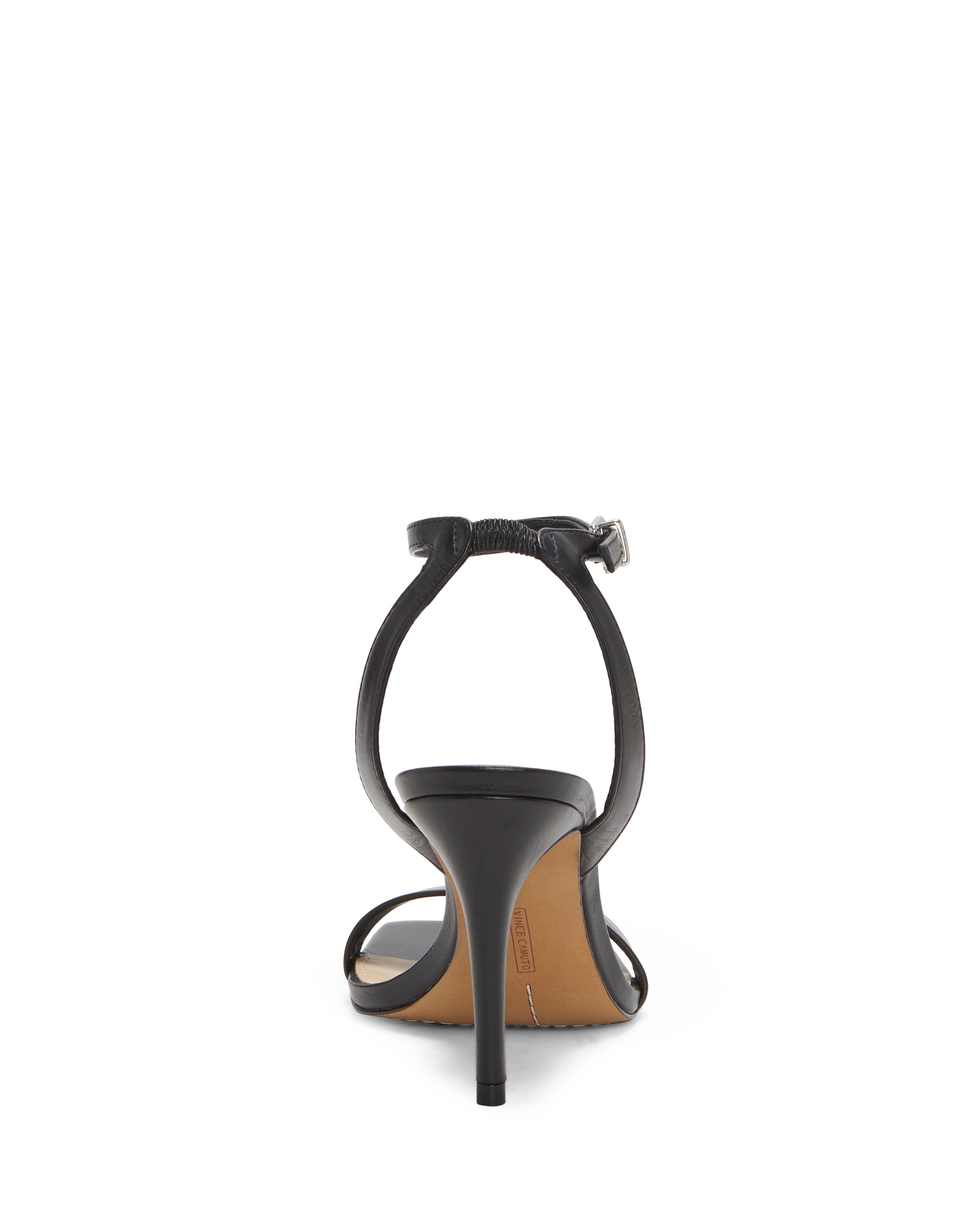 The Saprenda Sandal by Vince Camuto is a black dress sandal seen from the back, featuring a thin ankle strap with buckle, open heel, tan sole, and slim tapered heel for an elegant finish.