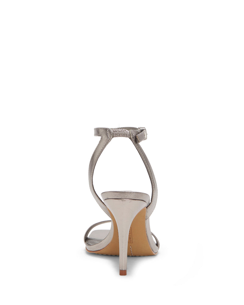 The Saprenda Sandal by Vince Camuto is shown from the back, highlighting its sleek ankle strap with a buckle and open toe design. Crafted from chic metallic leathers, it features a slim, moderately high heel.