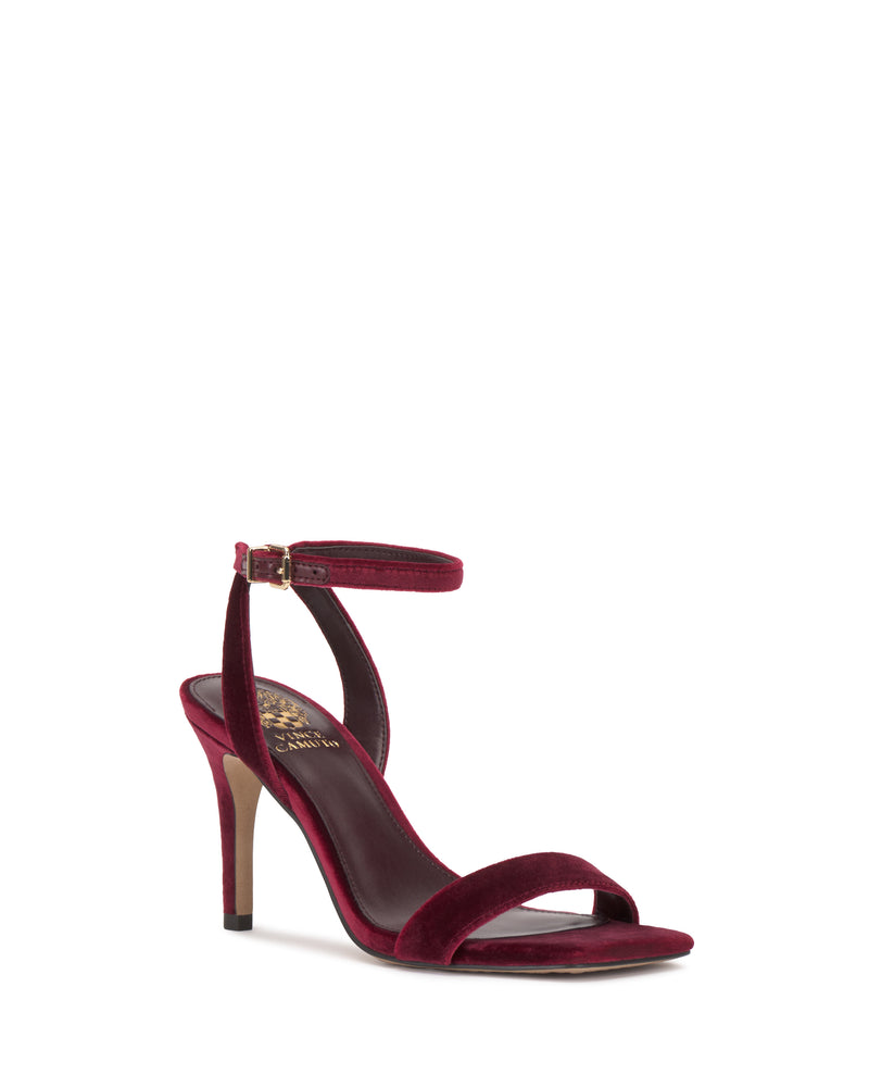 The Vince Camuto Saprenda Sandal is a burgundy velvet dress sandal featuring a sleek ankle strap and open toe, displayed on a white background.