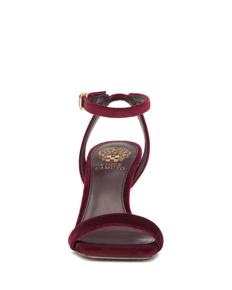 Front view of the Saprenda Sandal by Vince Camuto, a burgundy velvet dress sandal with an ankle strap and gold buckle, featuring the Vince Camuto logo on the insole.
