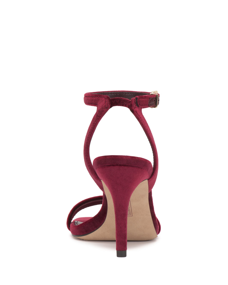 Back view of the Vince Camuto Saprenda Sandal in red velvet, featuring an ankle strap and a thin heel, displayed on a white background.