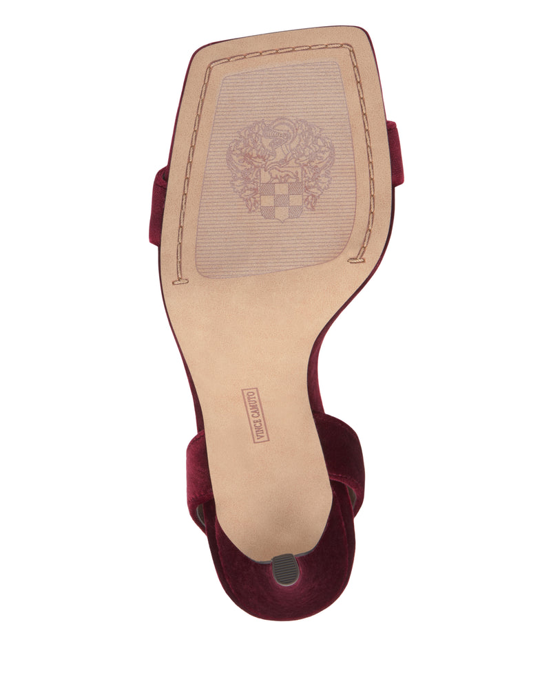 The bottom of the Vince Camuto Saprenda Sandal showcases a tan sole with a decorative crest, detailed edge stitching, and a visible rubber grip near the heel. Subtle hints of metallic leathers enhance this refined design with an elegant touch.