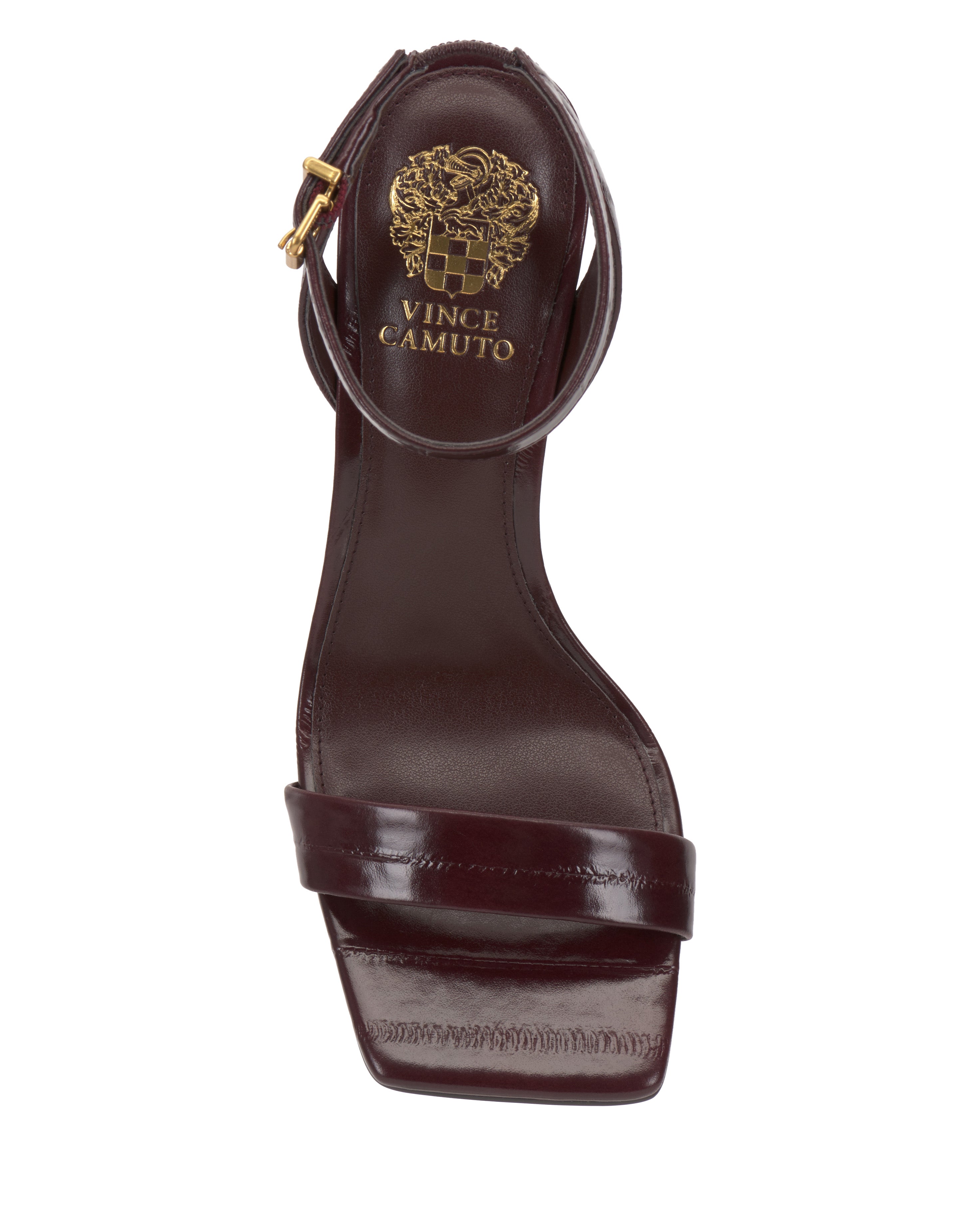 The Vince Camuto Saprenda Sandal in burgundy features a square toe, wide front strap, and ankle strap with a gold buckle. Shown from the top view, the brand logo is visible on the insole.
