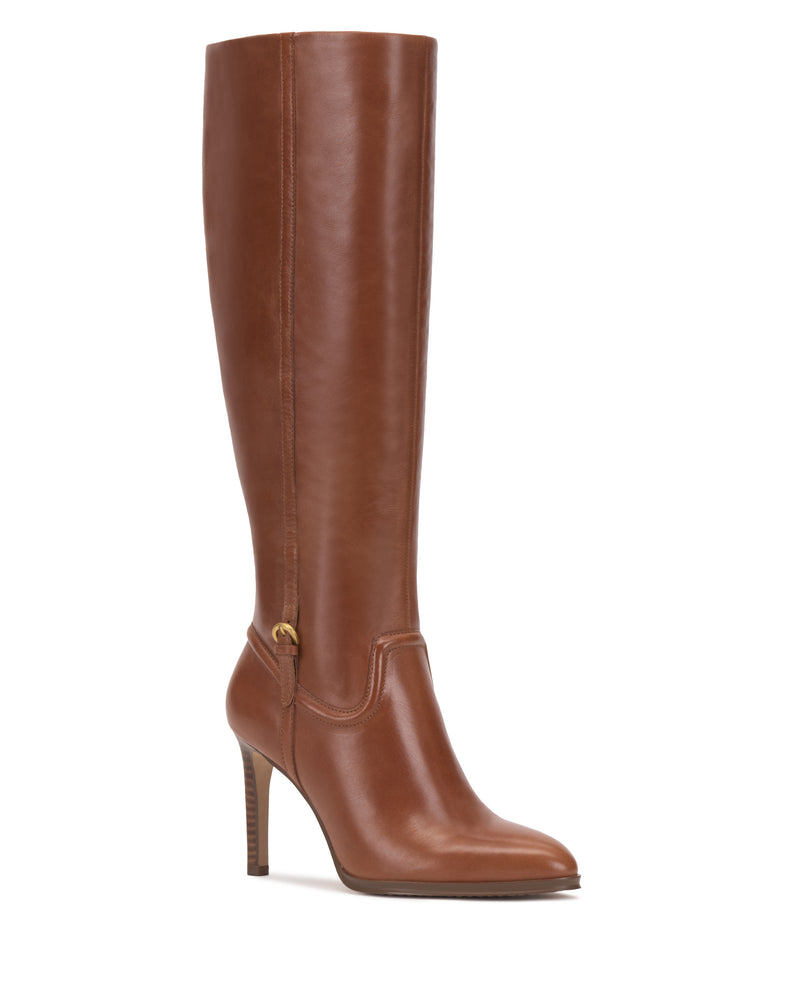 The Sareya Wide Calf Knee High Boot by Vince Camuto is a tall, brown leather boot featuring a pointed toe, high heel, and gold buckle detail near the ankle, photographed against a white background.