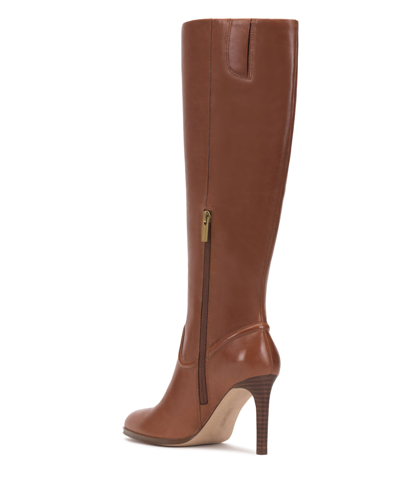 The Sareya Wide Calf Knee High Boot by Vince Camuto is a tall brown leather boot featuring a side zipper and pointed toe, displayed from a side angle on a white background.