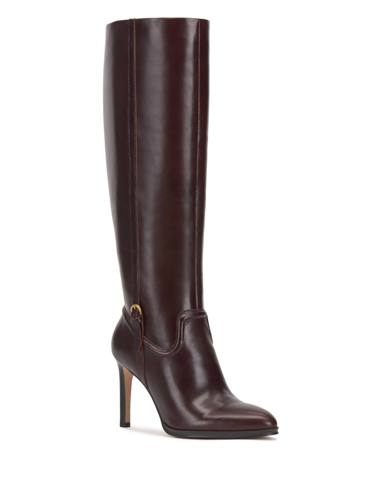 The Vince Camuto Sareya Knee High Boot features a tall silhouette crafted from dark brown leather, designed with a pointed toe, high stiletto heel, and subtle decorative side stitching for a sleek and sophisticated look.
