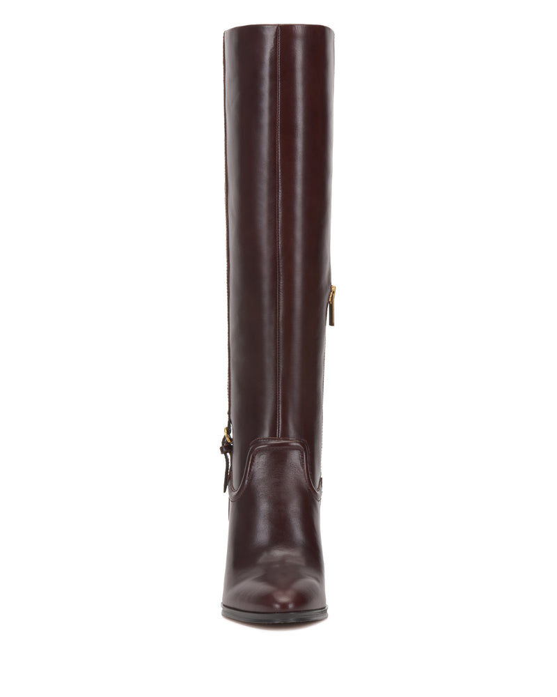 A tall, dark brown Sareya Knee High Boot by Vince Camuto is displayed from the front, showcasing a side zipper with a gold pull. Made from premium leather, the boot features a smooth, shiny finish and a rounded toe for a sleek silhouette.