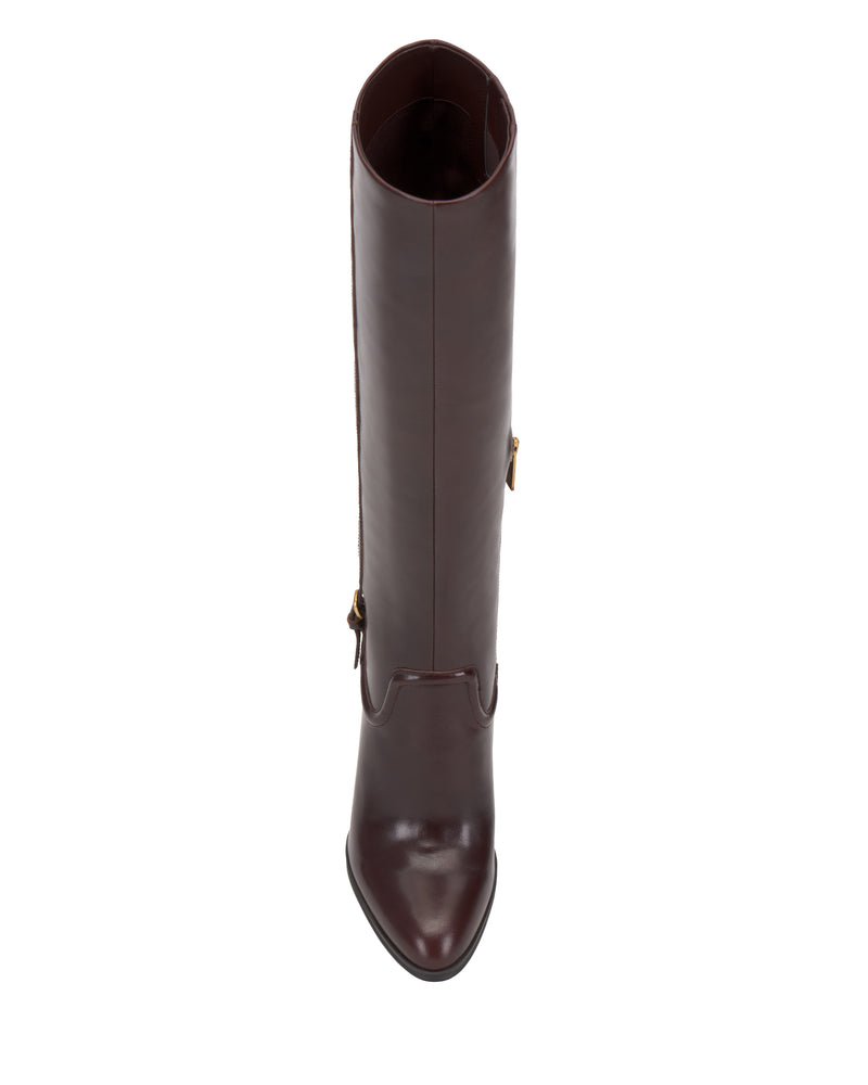 Top view of the Sareya Knee High Boot by Vince Camuto—a single tall, dark brown leather boot with a pointed toe and side zipper, expertly crafted from premium materials and featuring a sleek silhouette, displayed against a white background.