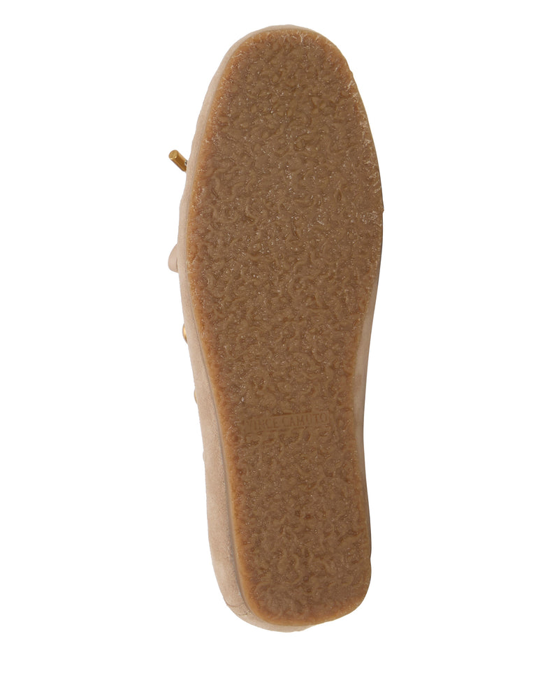 The image shows the textured rubber sole of the Vince Camuto Sennett Studded Moccasin in beige suede, viewed from the bottom, highlighting its grippy studded pattern and a slightly raised heel.