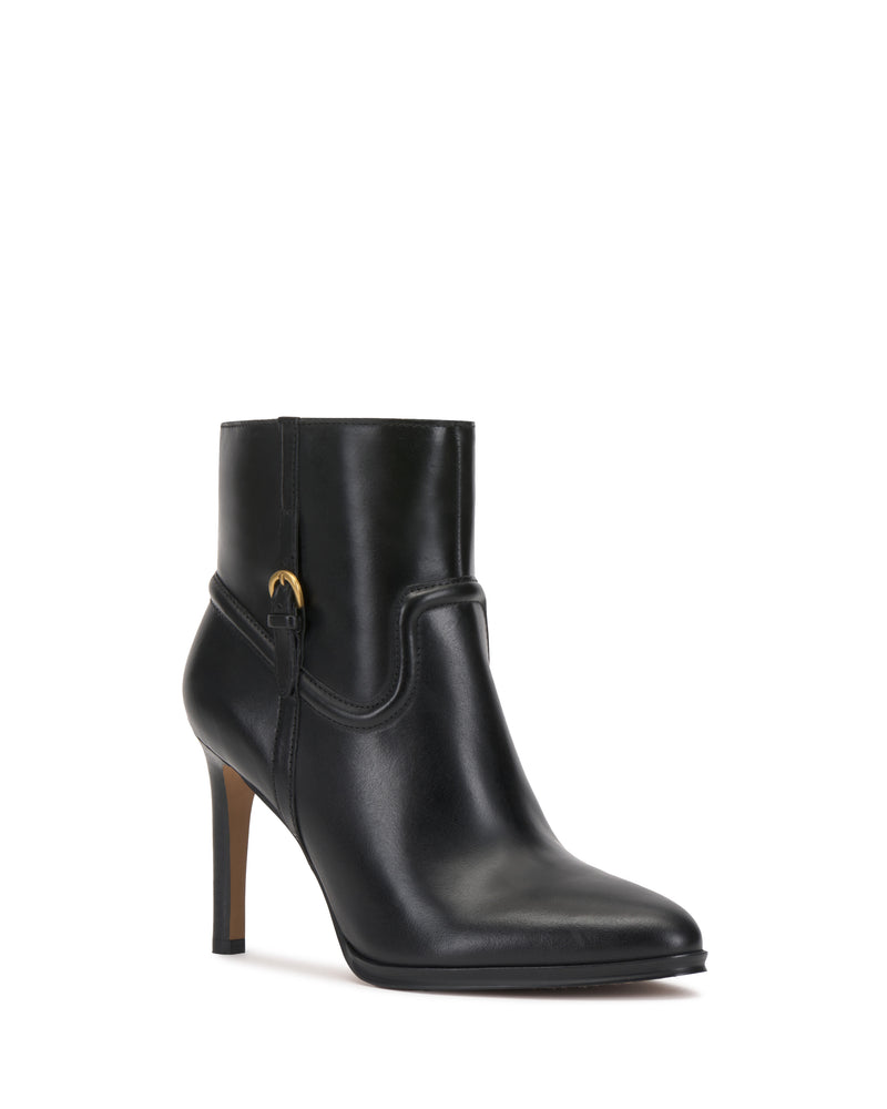 The Setily Bootie by Vince Camuto features a black leather upper, high heel, pointed toe, side buckle detail, and a sleek, minimalist design. The boot is displayed against a plain white background.