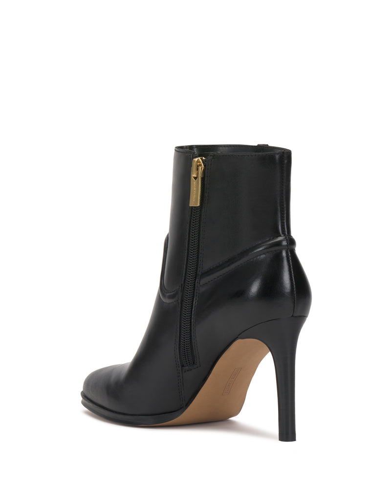 The Setily Bootie by Vince Camuto is a black high-heeled ankle boot featuring a pointed toe, side zipper with a gold zipper pull, and a smooth leather finish, shown against a white background.