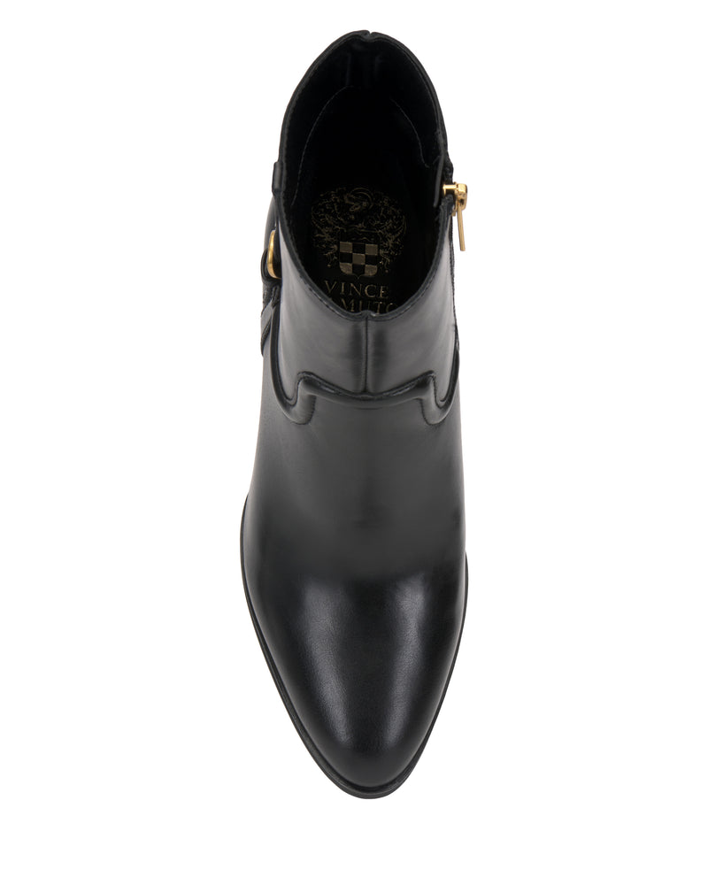 Top view of the Setily Bootie by Vince Camuto, a single black leather ankle boot featuring a pointed toe, gold buckle detail on the side, and decorative stitching around the ankle area. The Vince Camuto brand logo is visible inside the boot.