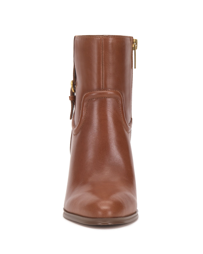 Front view of the Vince Camuto Setily Bootie in brown leather, featuring a side zipper, subtle stitching details, a rounded toe, and a smooth finish.