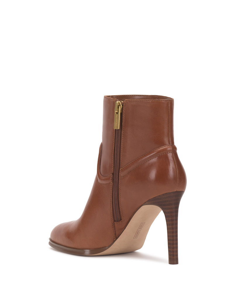 Setily Bootie by Vince Camuto in brown leather, featuring a high stacked wooden heel and side zipper, photographed on a white background.