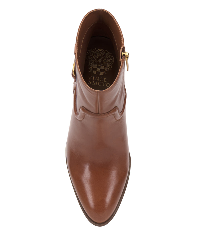 Top view of the Vince Camuto Setily Bootie— a brown leather ankle boot featuring a pointed toe, gold buckle detail, and the Vince Camuto logo visible on the insole. The boot is centered on a white background.