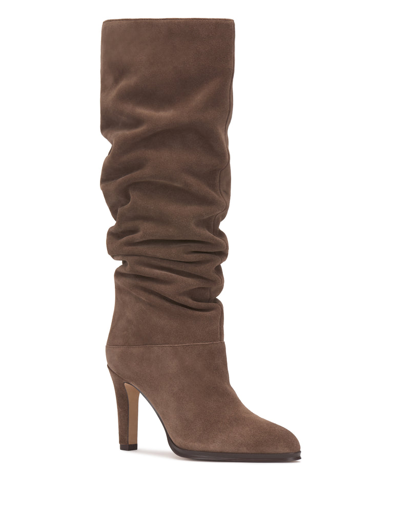 Featuring a slouchy shaft and high heel, the Vince Camuto Sorina Wide Calf Knee High Boot is a stylish brown suede knee-high boot, showcased against a white background.