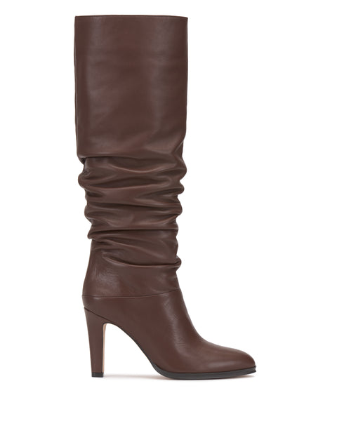 The Vince Camuto Sorina Extra Wide Calf Knee High Boot is a brown leather knee-high style featuring a slouchy shaft and high heel, shown in side profile on a white background—ideal for those searching for fashionable slouchy boots with an extra wide-calf fit.