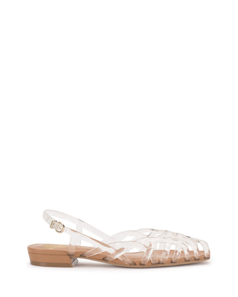 The Vince Camuto Stiorra Sandal is a clear woven jelly flat with a braided design, closed toe, low tan heel, and ankle strap with buckle, shown on a white background.