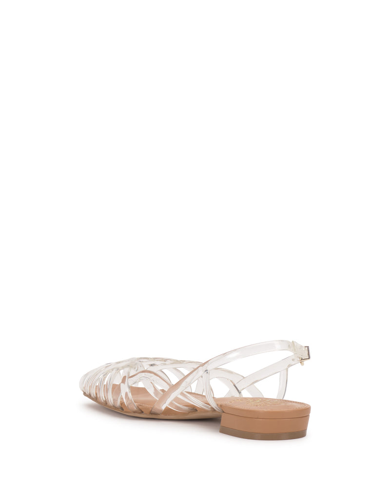 The Vince Camuto Stiorra Sandal is a clear, strappy flat with braided detail and a slingback strap, featuring a low tan heel. Shown from the rear against a white background.