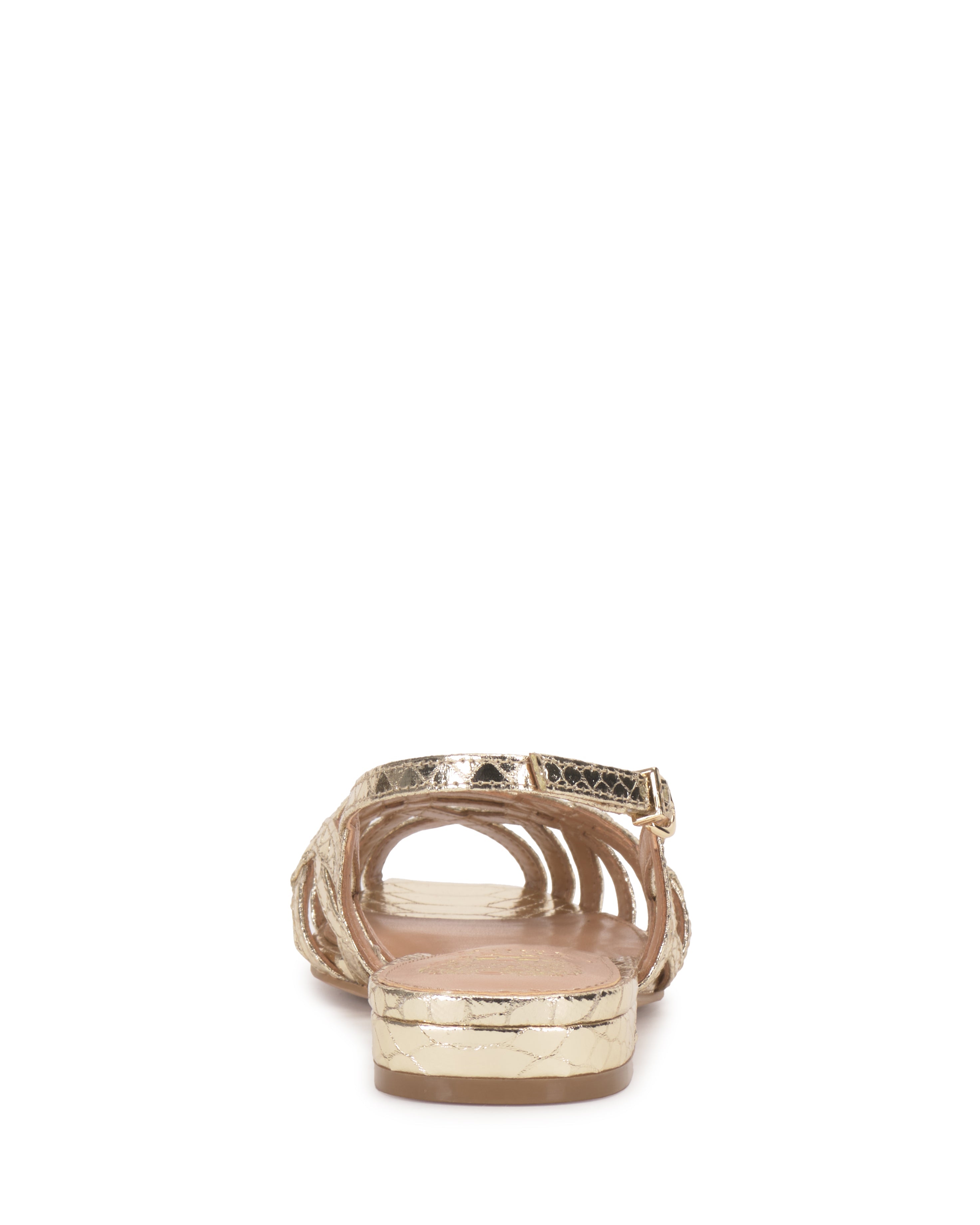 A rear view of the Vince Camuto Stiorra Sandal shows its textured metallic low block heel, open toe, and elegant braided detailing, with a light pink insole set against a plain white background.
