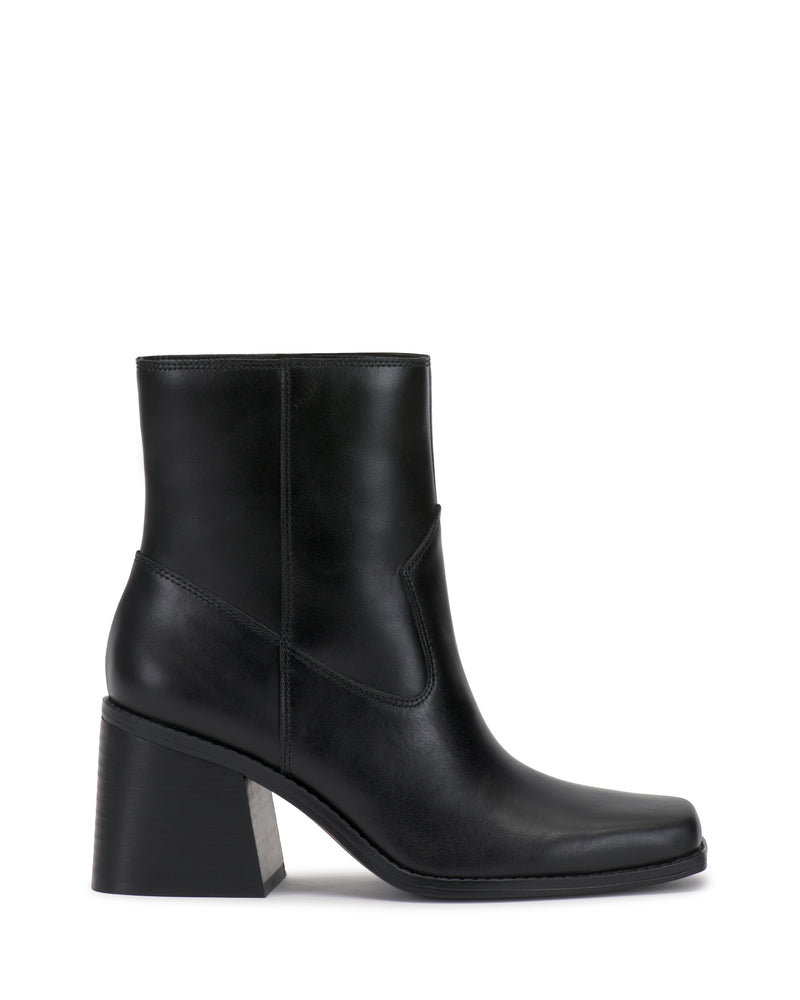 The Sybren Bootie by Vince Camuto features black leather, a chunky block heel, smooth finish, and side stitching detail, exuding modern sophistication against a white background.
