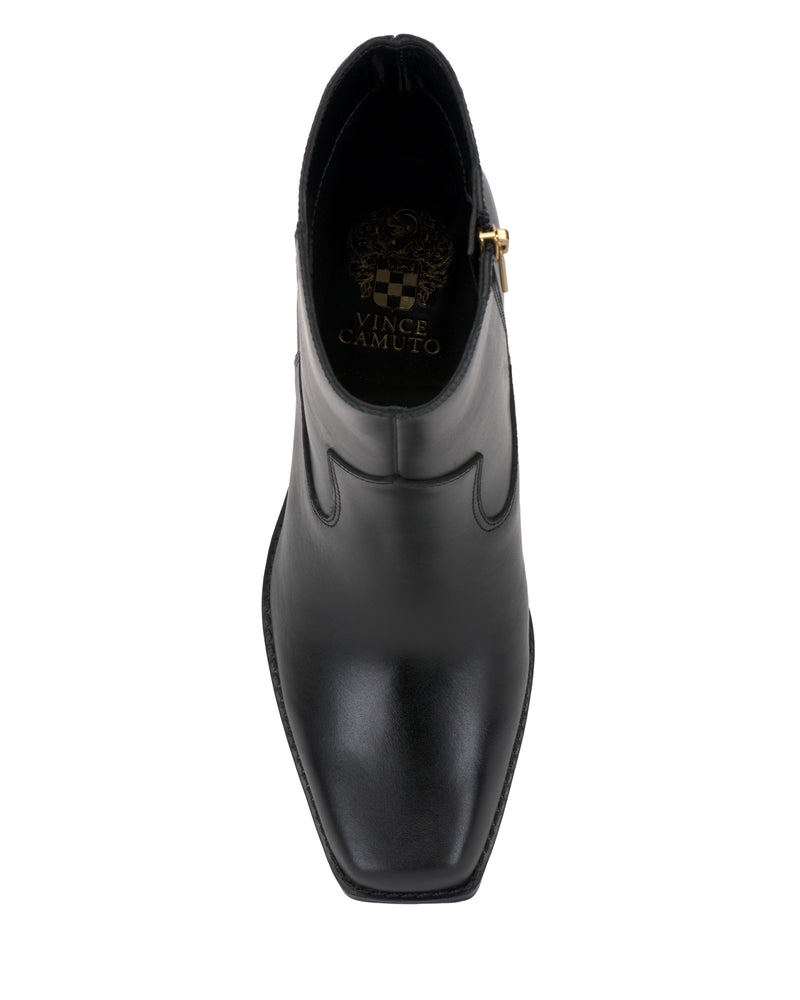 Top view of the Sybren Bootie by Vince Camuto, featuring a black leather western-inspired design with a pointed toe and gold side zipper, highlighted by the Vince Camuto logo in gold on the insole for an added touch of modern sophistication.