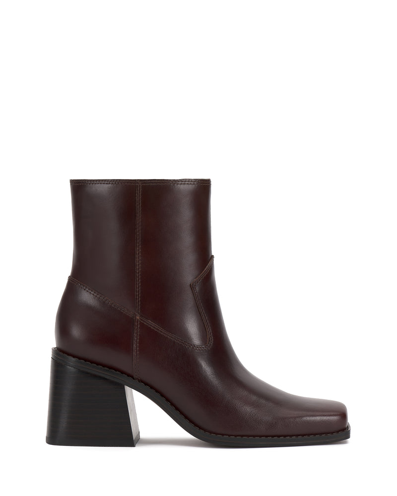 The Sybren Bootie by Vince Camuto is a dark brown leather ankle boot featuring a square toe and chunky block heel, showcasing modern sophistication in its side profile view against a white background.