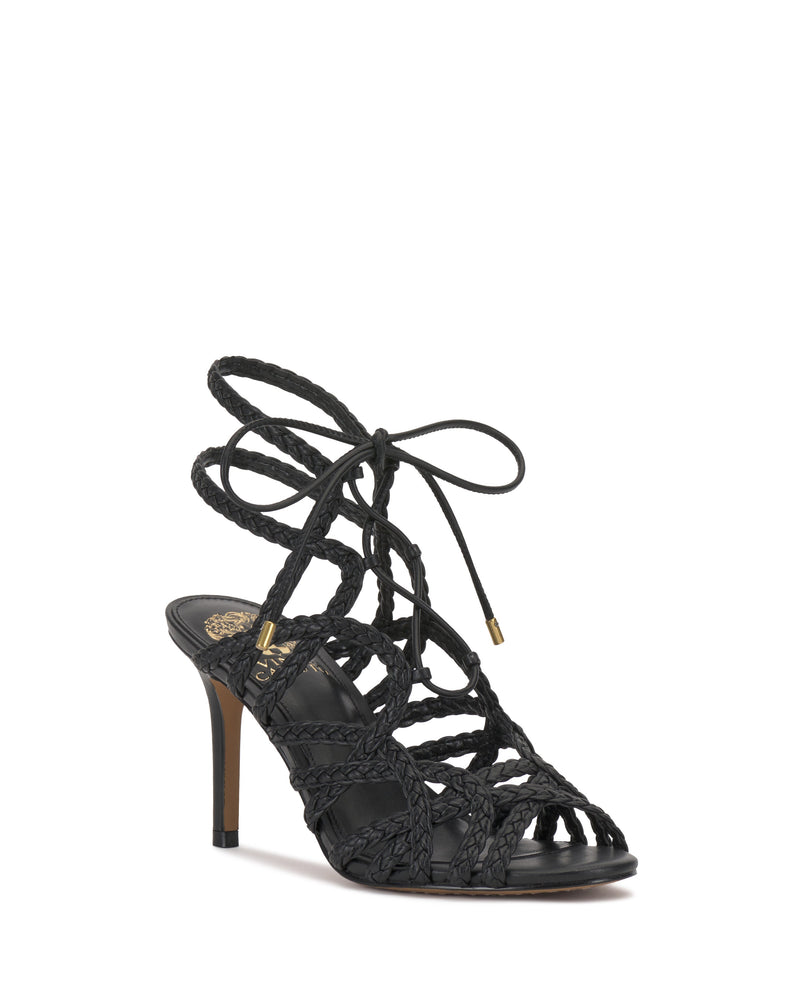 The Tilly Sandal by Vince Camuto features black braided leather straps, a lace-up design, open toe, and medium-height heel, combining elegance and style for any occasion.
