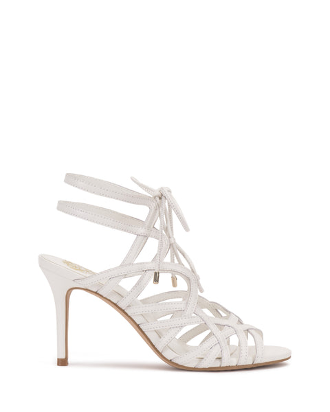 The Tilly Sandal by Vince Camuto is a white strappy stiletto with a lattice pattern, open toe, two ankle straps, and an elegant lace-up front. A smooth sole ensures comfort.