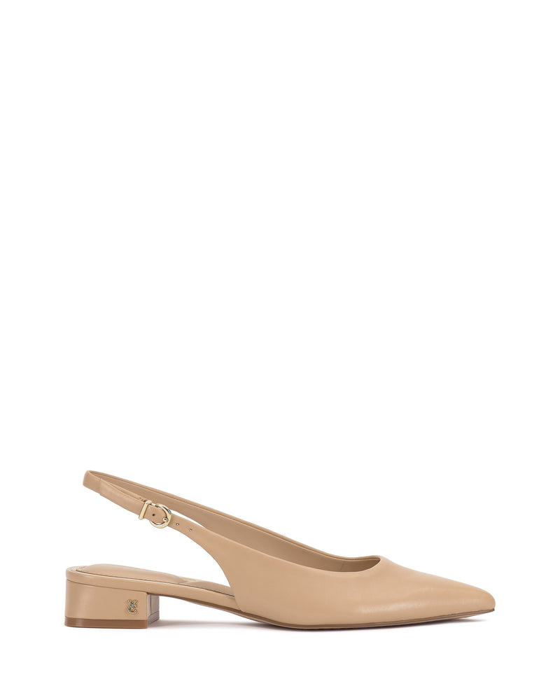 The Vince Camuto Valiey Slingback Pump is a beige mule with a pointed toe, low block heel, adjustable buckle strap, and a small gold logo on the heel. Shown on a white background.