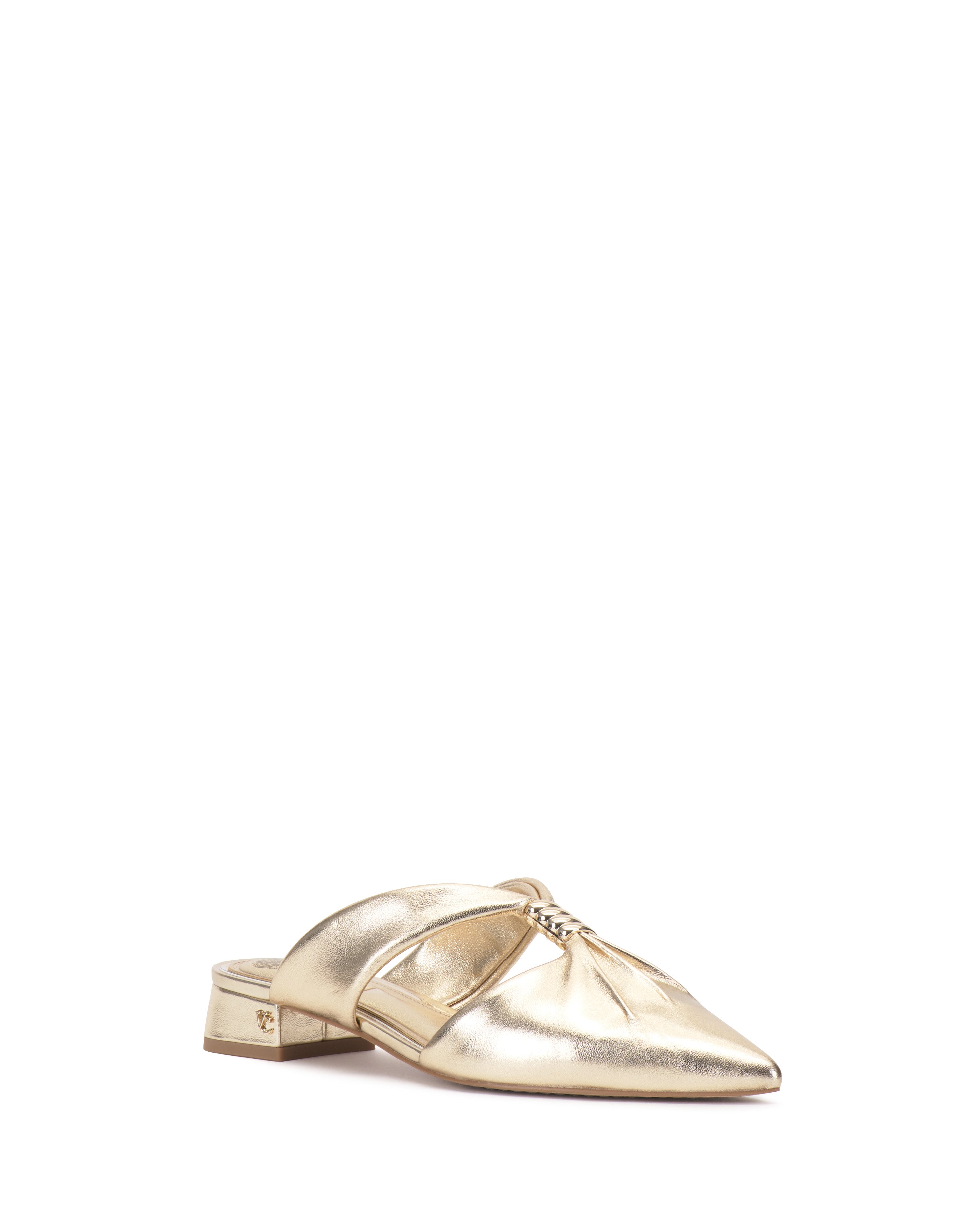 The Vince Camuto Vanika Mule is a gold metallic shoe featuring a pointed toe, low block heel, and chain detail across the top, shown against a white background.