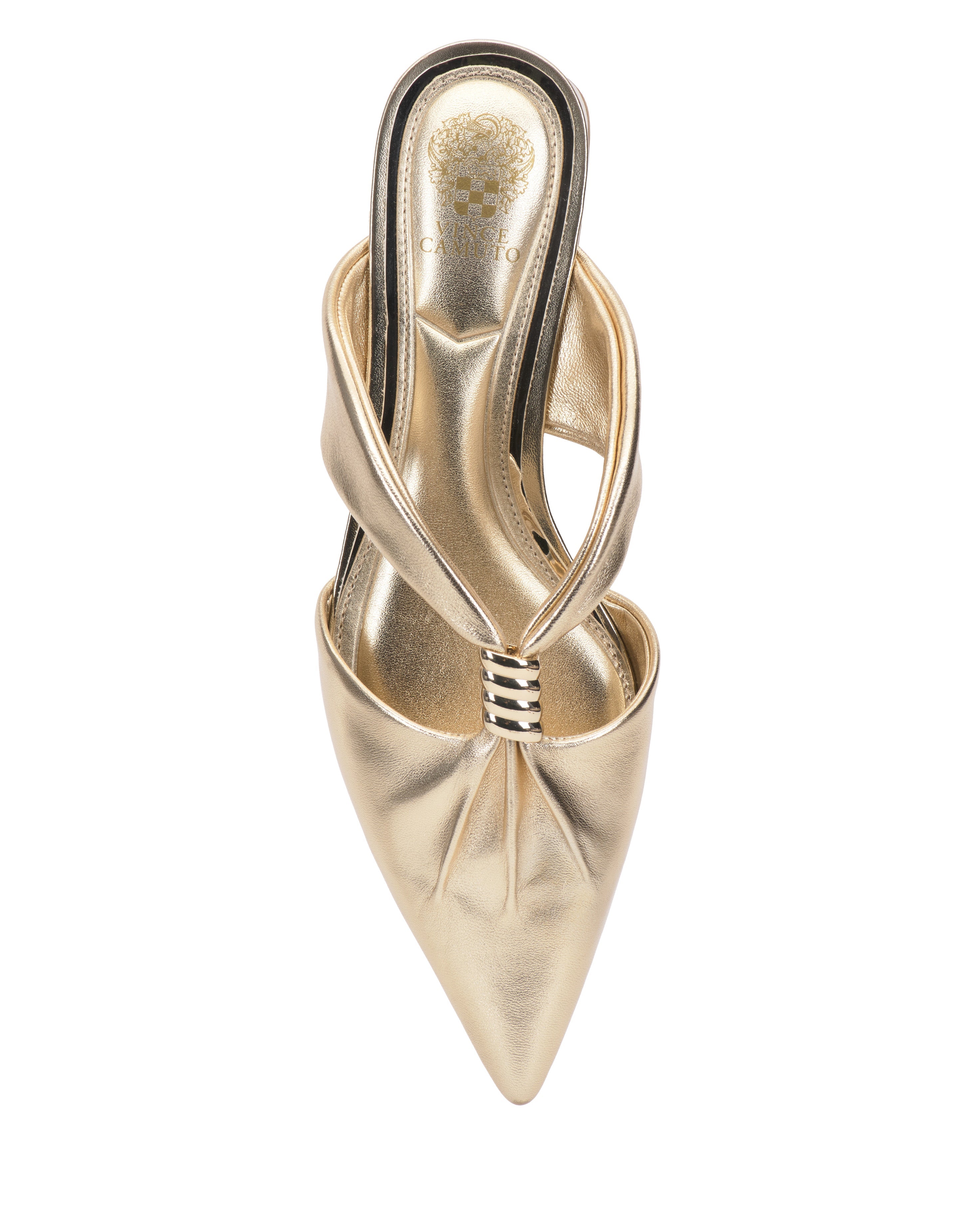 The Vanika Mule by Vince Camuto is a gold pointed-toe high heel with crisscross straps, pleated detailing, and a decorative gold logo on the insole, showcasing elegant design from an overhead view.
