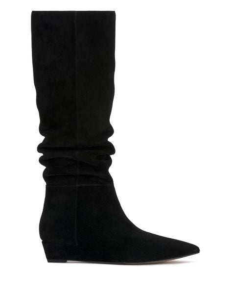 The Vanisa Knee High Boot by Vince Camuto, shown in a left side profile against a white background, features black suede in a slouch design with a pointed toe and a low wedge heel.