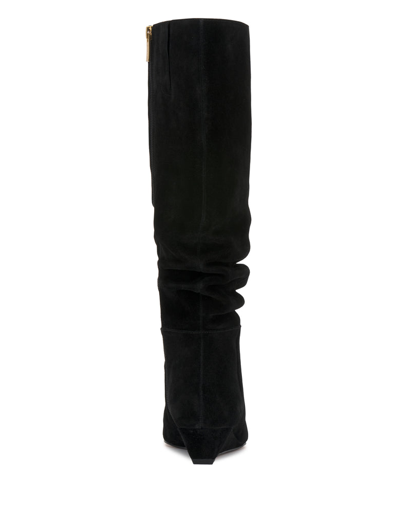 The Vanisa Knee High Boot by Vince Camuto is shown in black suede from a rear view, displaying its subtly slouched silhouette and a small visible zipper at the top.