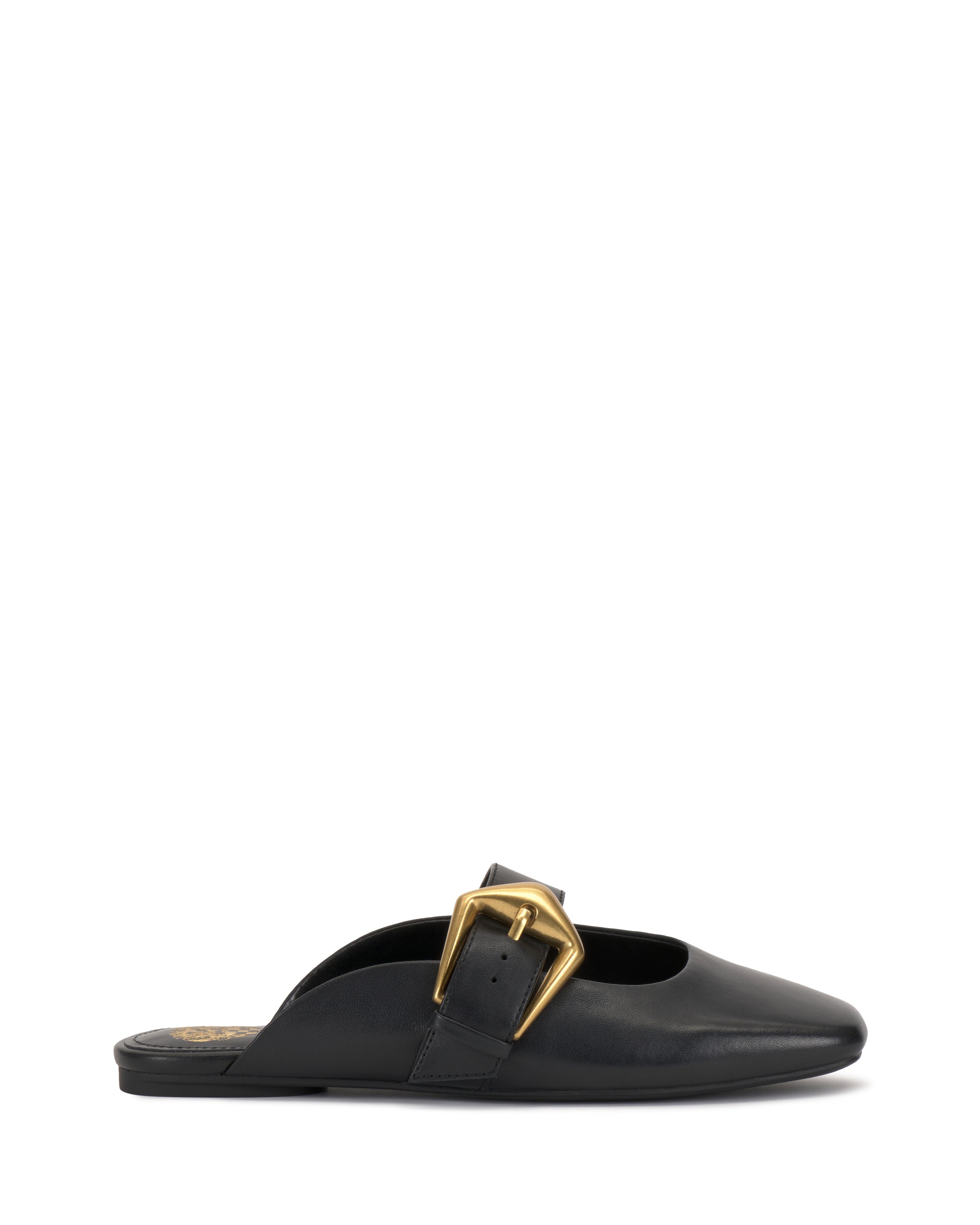 The Vellma Buckle Mule by Vince Camuto is a black leather slip-on with a pointed toe, flat sole, and features a large gold buckle detail on the upper side.