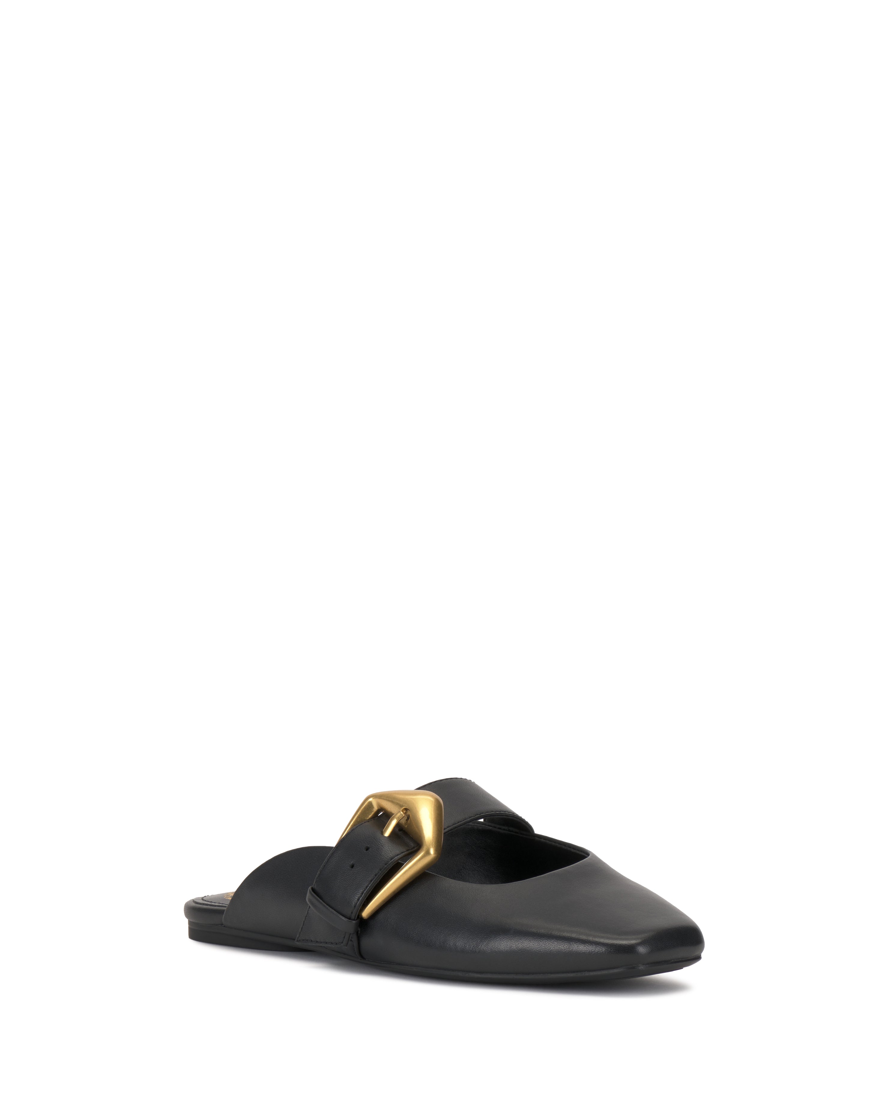 The Vellma Buckle Mule by Vince Camuto is a black leather slip-on flat with a pointed toe and a bold gold buckle on the upper, shown on a white background.
