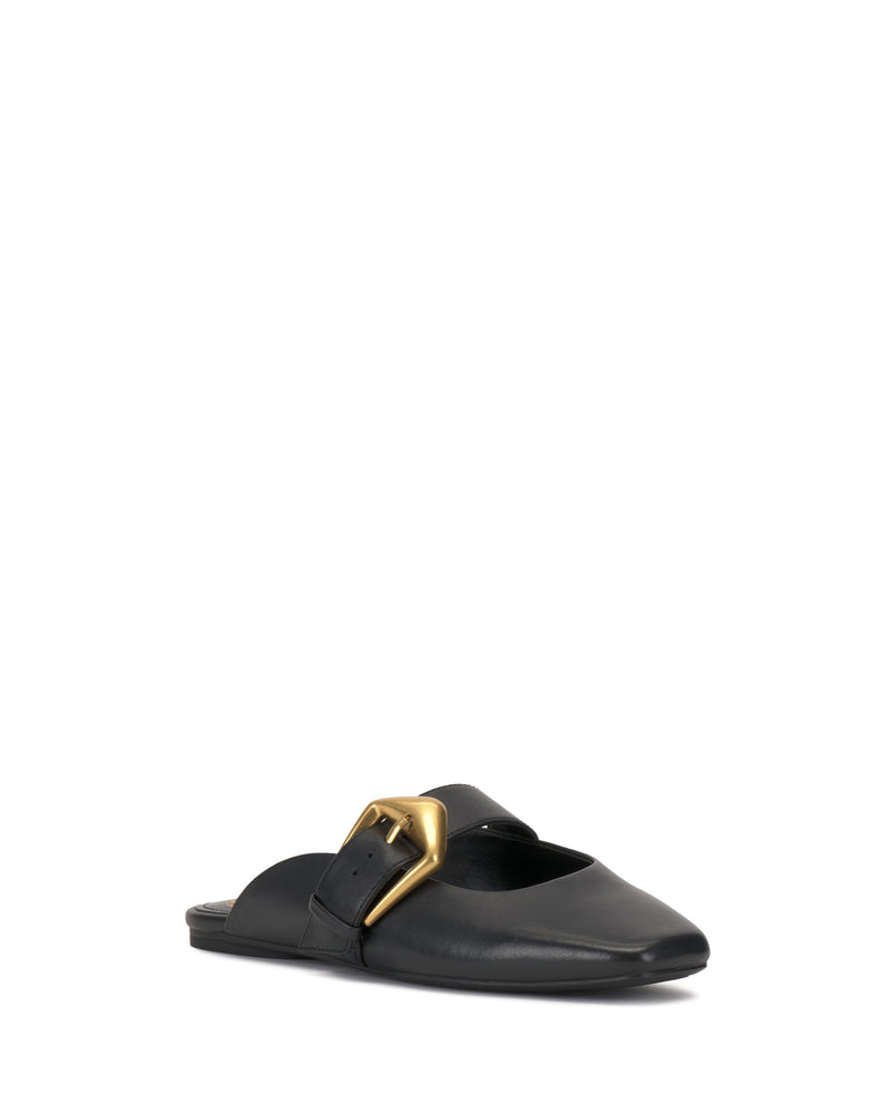 The Vince Camuto Vellma Buckle Mule is a black leather slip-on flat with a pointed toe and prominent gold buckle detail, shown against a white background.